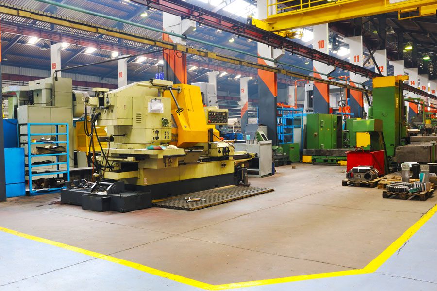 Clean, orderly warehouse interior with large colorful machinery