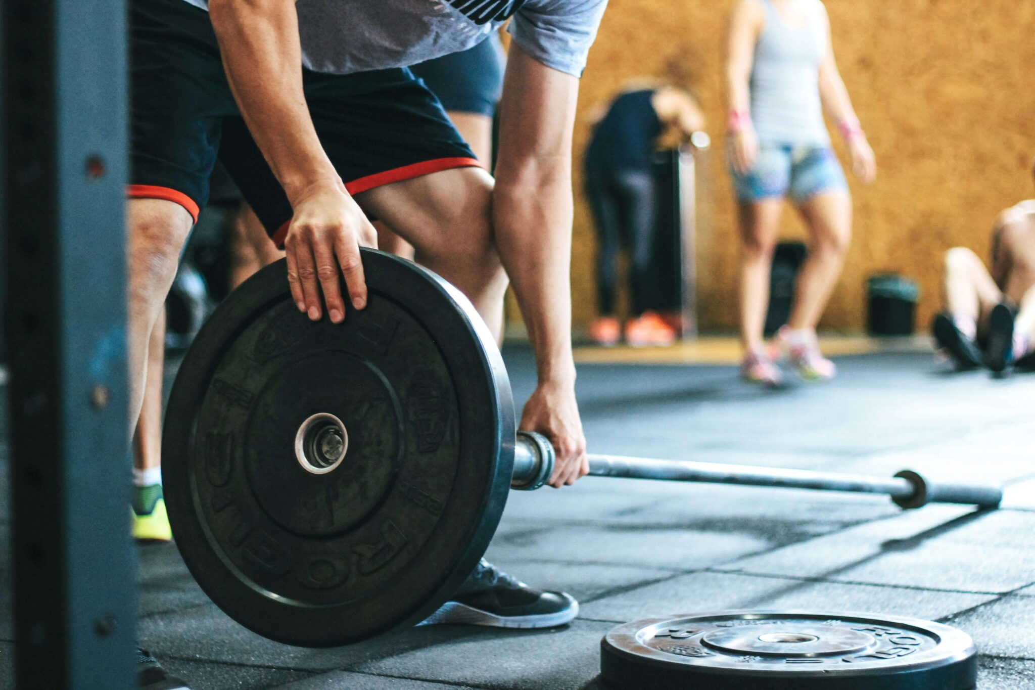 man putting together weights at gym