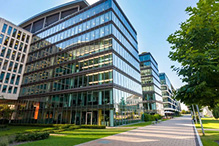 Exterior of Commercial building complex with sidewalk and green trees